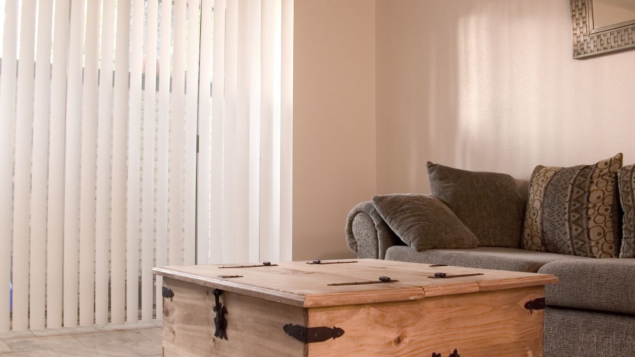A cozy living or family room with vertical blinds.