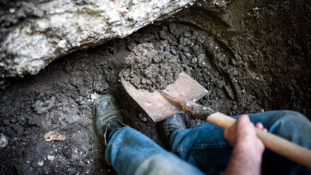 shovel in the dirt digging a hole
