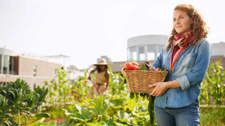 woman with vegetables on a rooftop garden