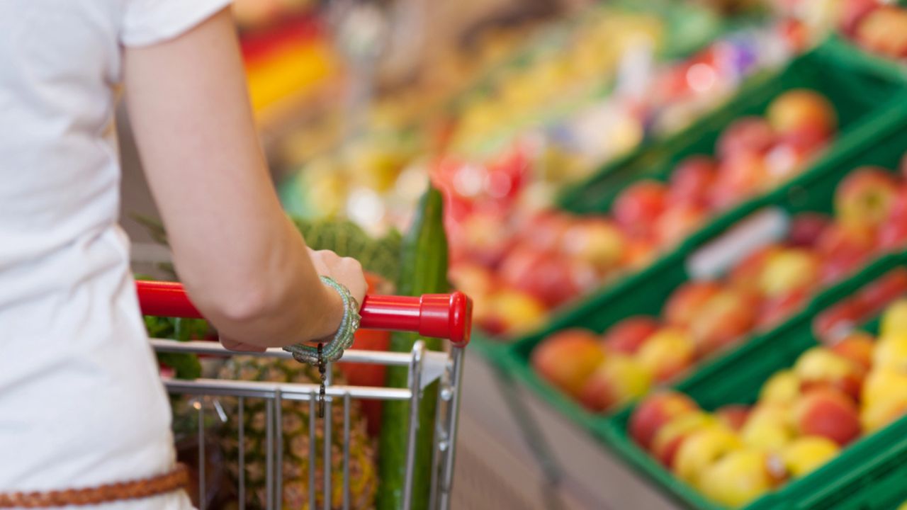 Cropped Image Of Woman Pushing Shopping Cart In Store