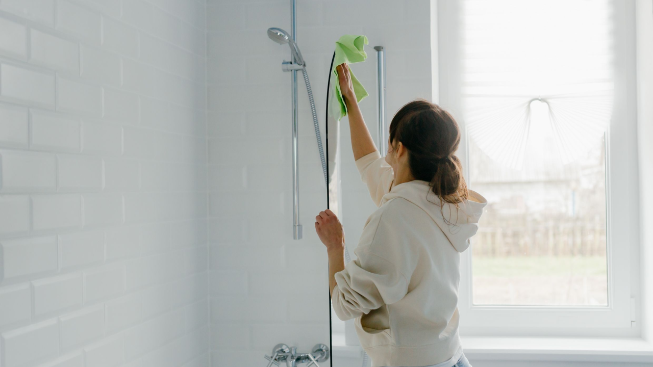 woman cleaning her shower bathroom