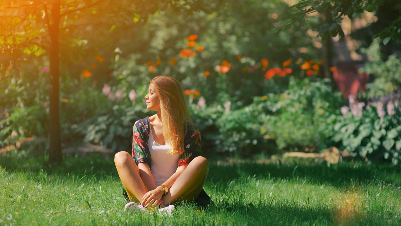 woman reflecting in her garden crossed legs meditation prayer