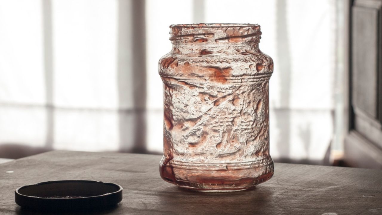 Strawberry jam jar leftovers in a rural kitchen