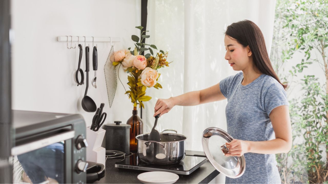 Young Asian woman making healthy food in kitchen at home