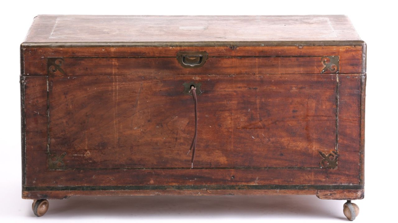 An antique campaign chest isolated on a white background