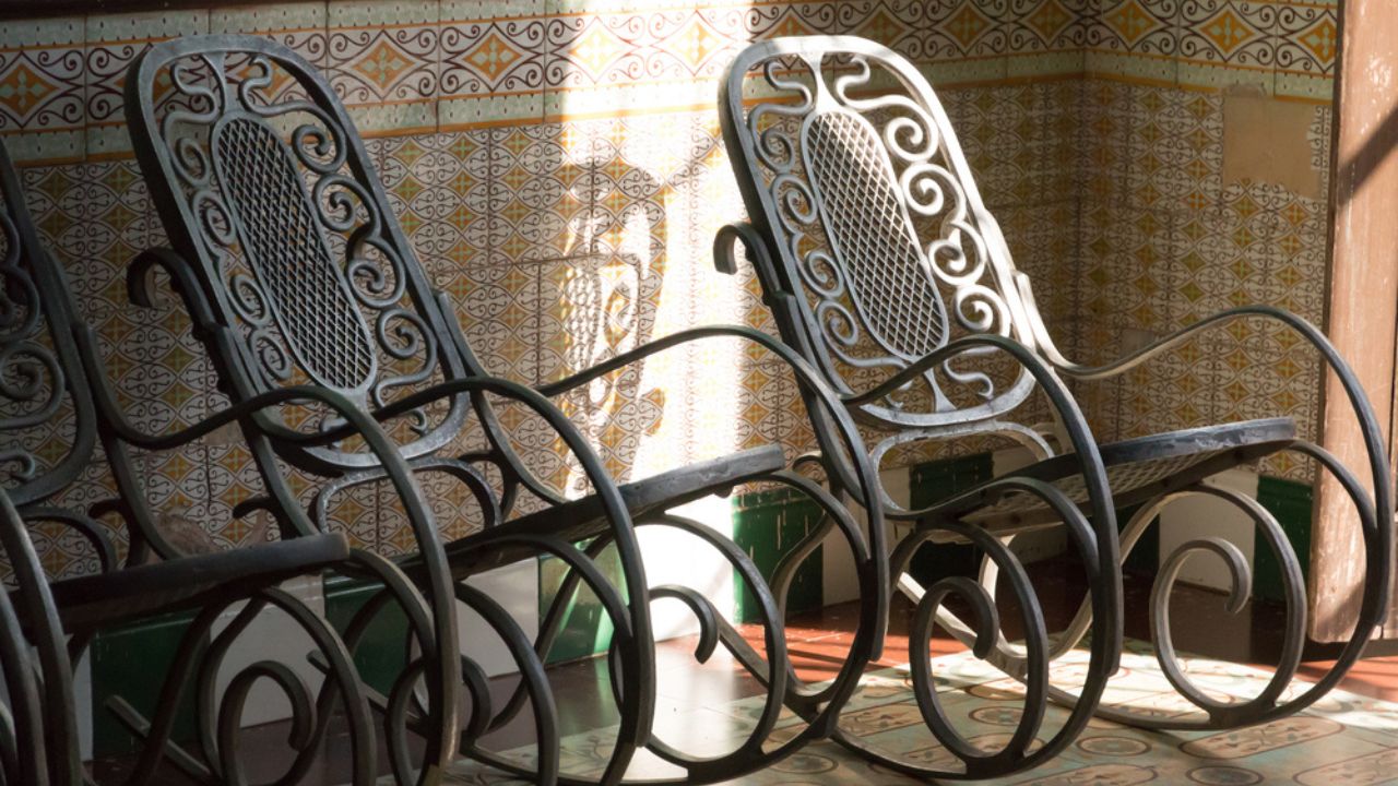 Cuba, Cienfuegos, Porch and bentwood rocking chairs.