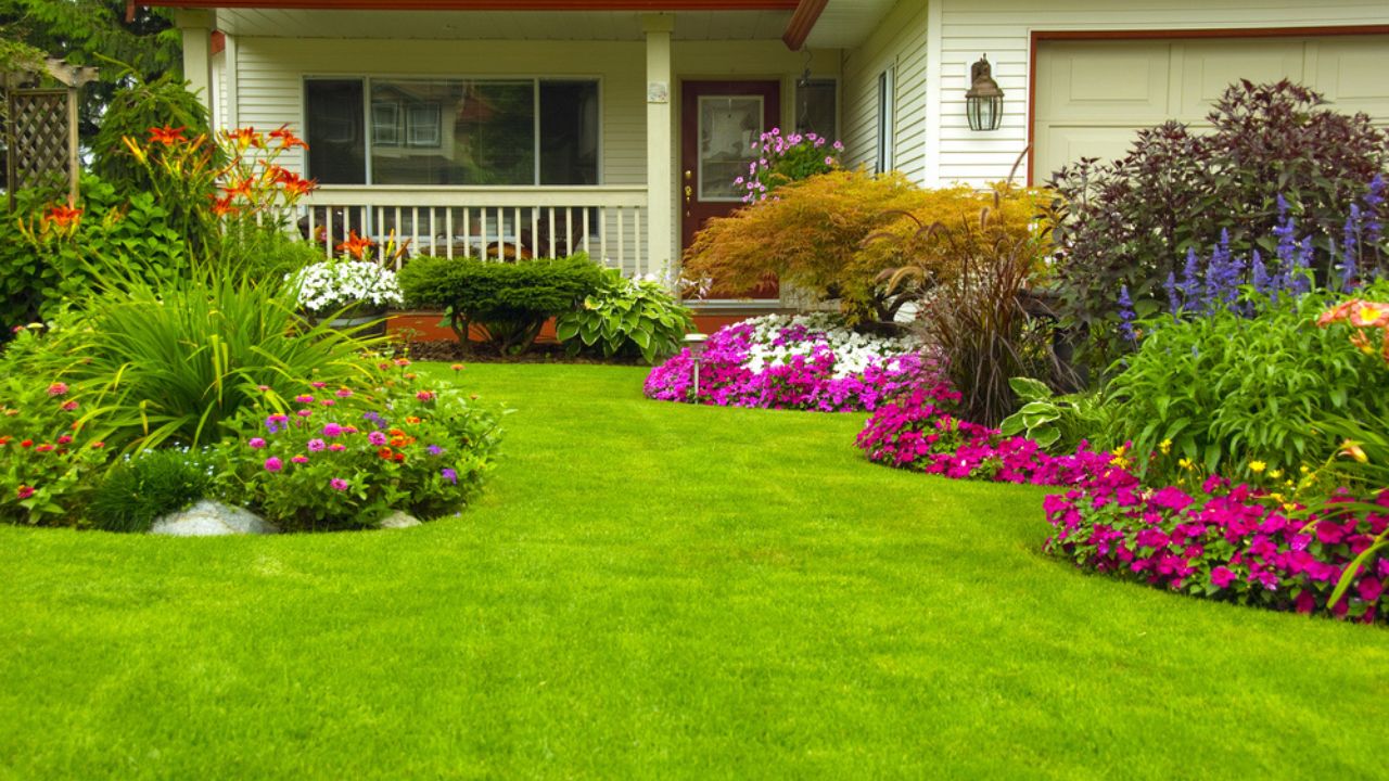 Manicured House and Garden displaying annual and perennial gardens in full bloom.