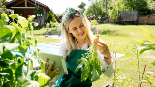 woman in the garden holding a tablet