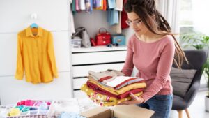 Woman organizing decluttering room clothes