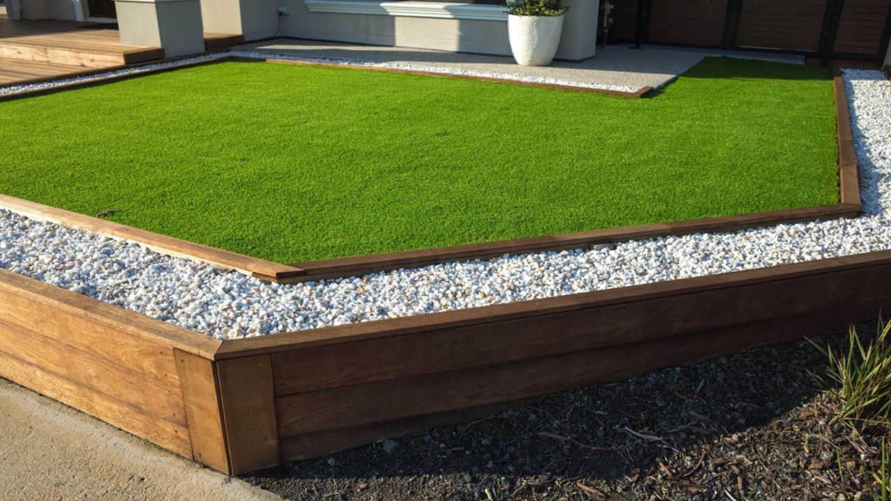Artificial grass lawn turf with wooden edging in the front yard of a modern Australian home or residential house.