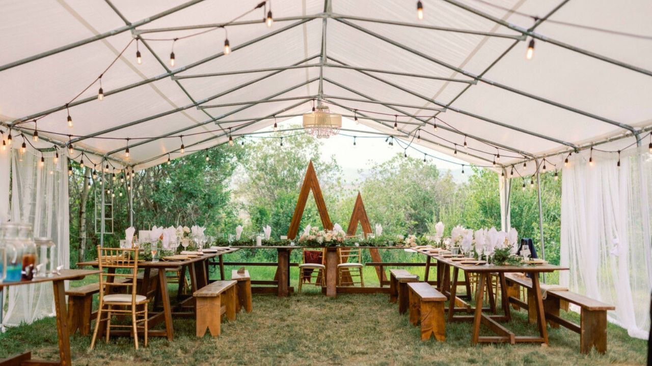 Elegant outdoor tented wedding reception setup