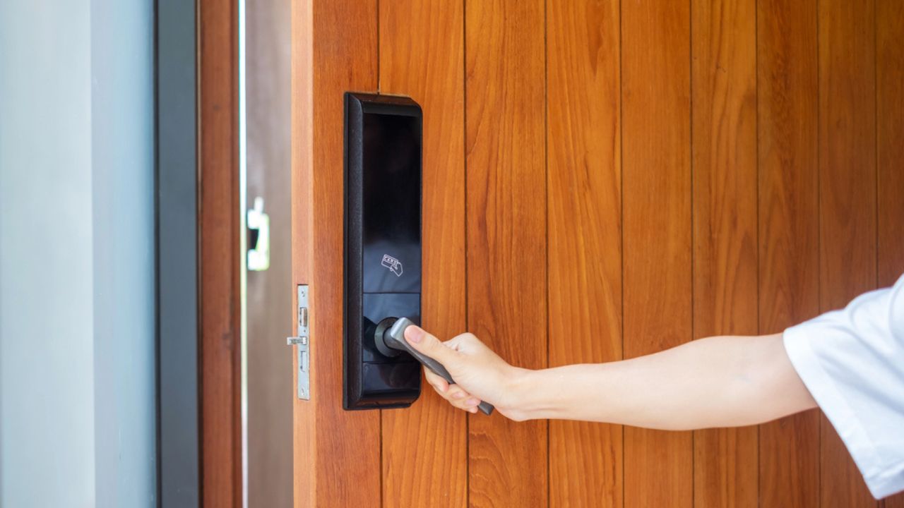 Man Holding Handle of Smart Digital Door Lock While Open or Close the Door. Technology, Electrical and Lifestyle Concepts