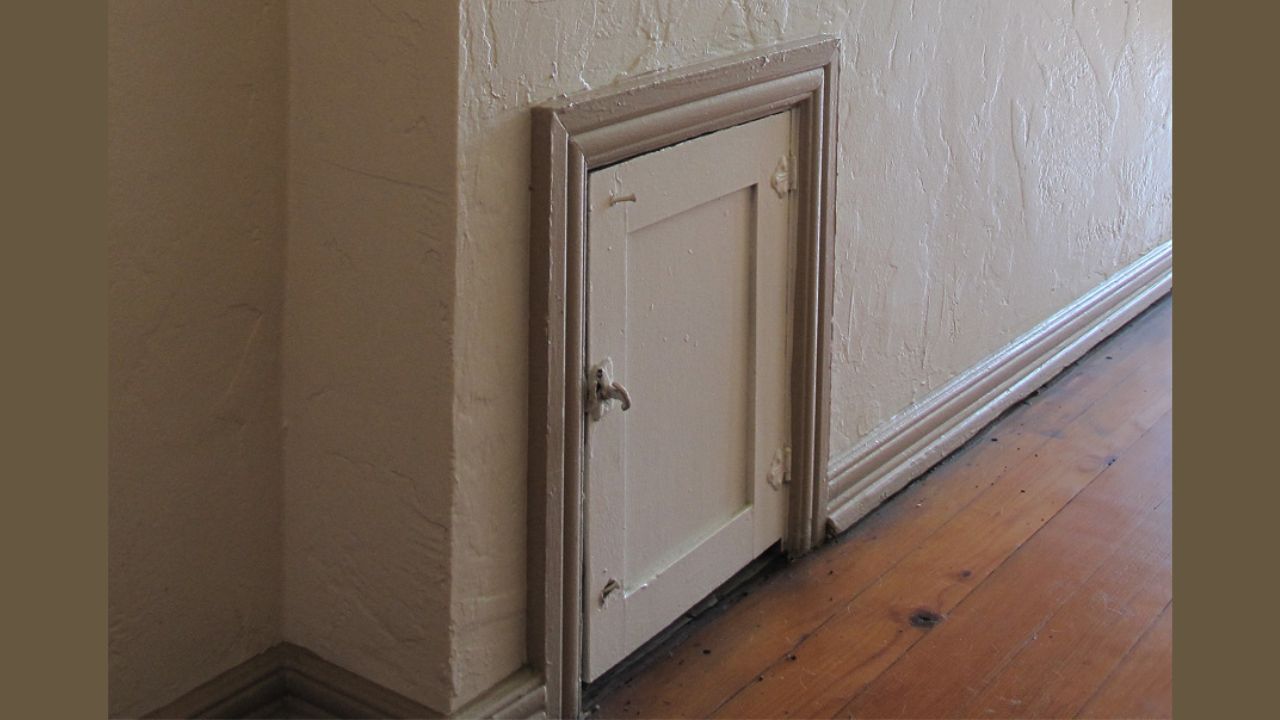 Milk delivery door, or package safe, in hallway outside 1920s apartment in Los Angeles, California.