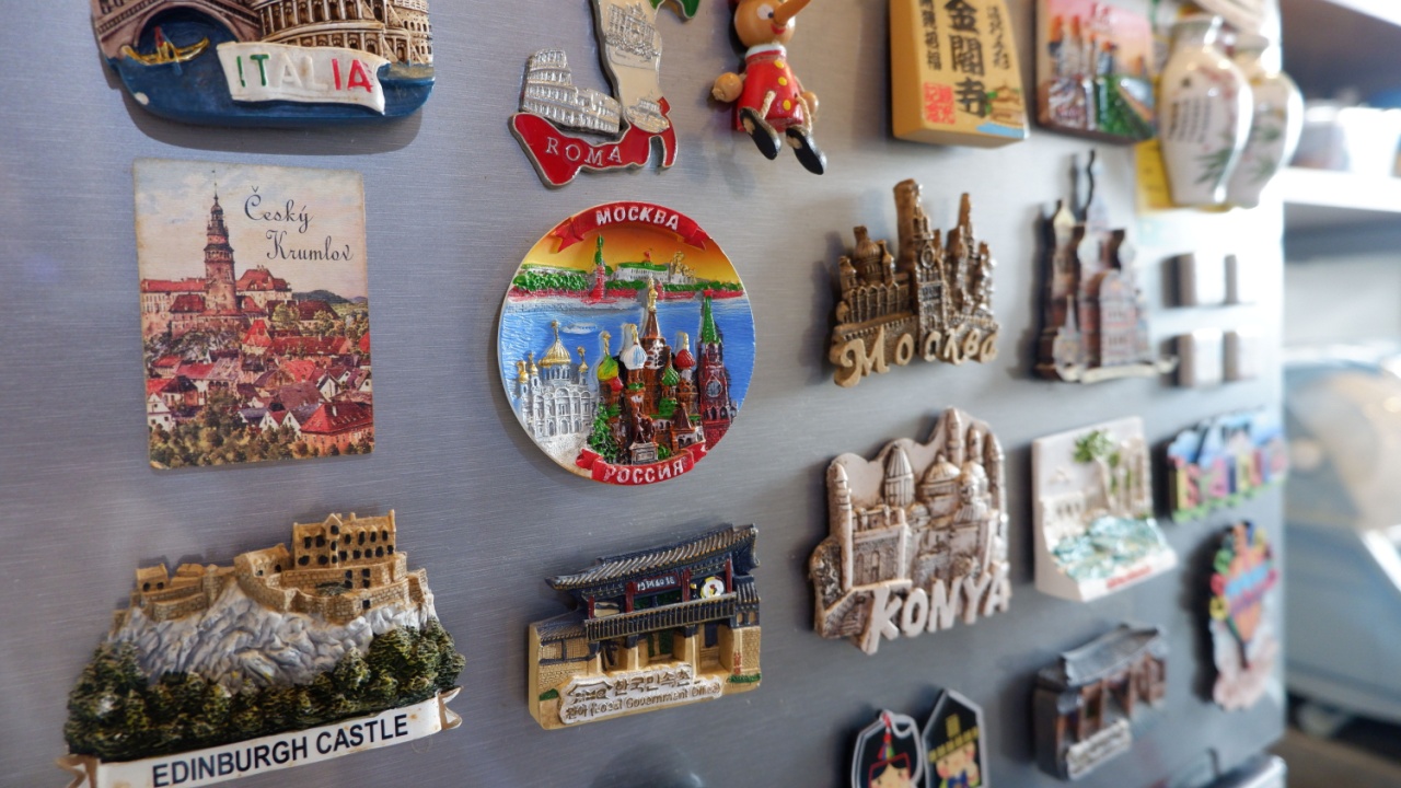 Mix of travel magnet from different countries and cities attached on a fridge. Those souvenirs are collected by many tourists after spending vacation.