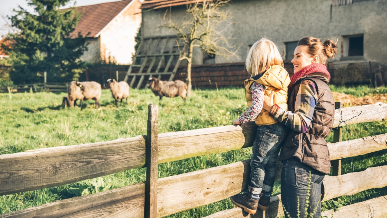 woman and child on their homestead fence farm