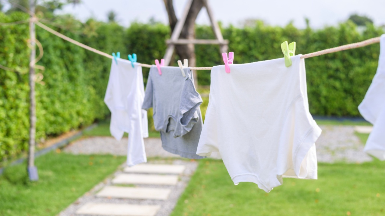 Clothes hanging laundry on washing line for drying against blue sky outdoor