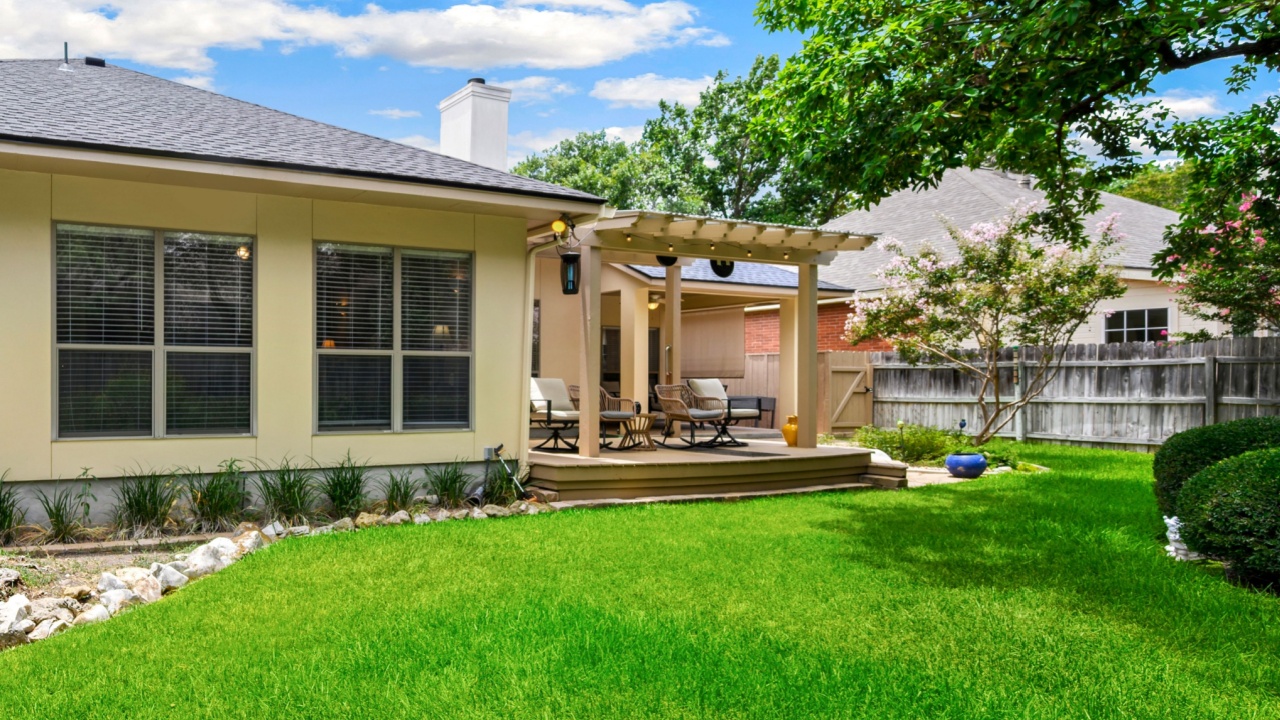 a home back yard with green grass