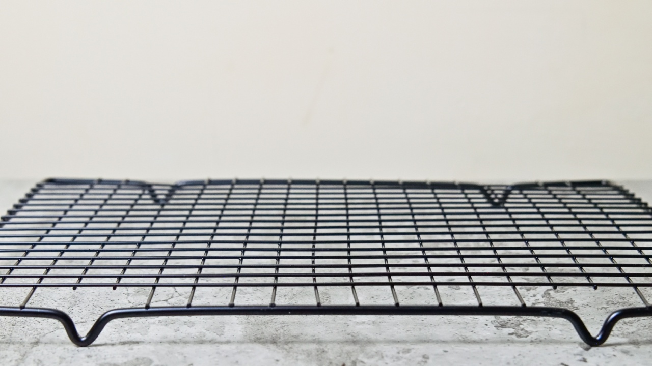 Side view of empty black baking rack. copy space, empty space, free space for food photo. close up, front.