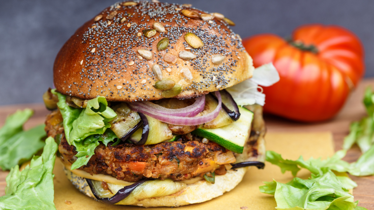 veggie burger cose up with bun and zucchini onion
