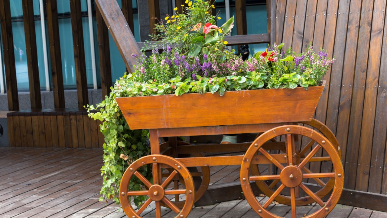 Flower bed-wheelbarrow wooden decoration in a garden