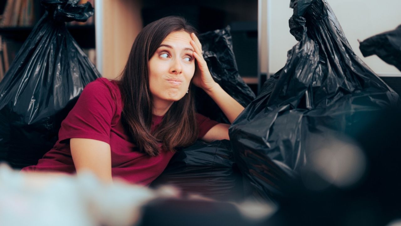 Woman Surrounded with Plastic Bags after De-cluttering and Editing her Wardrobe.