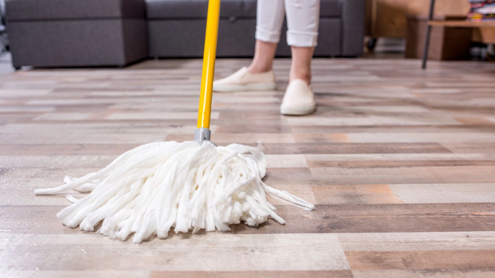 Woman cleaning floor with mop