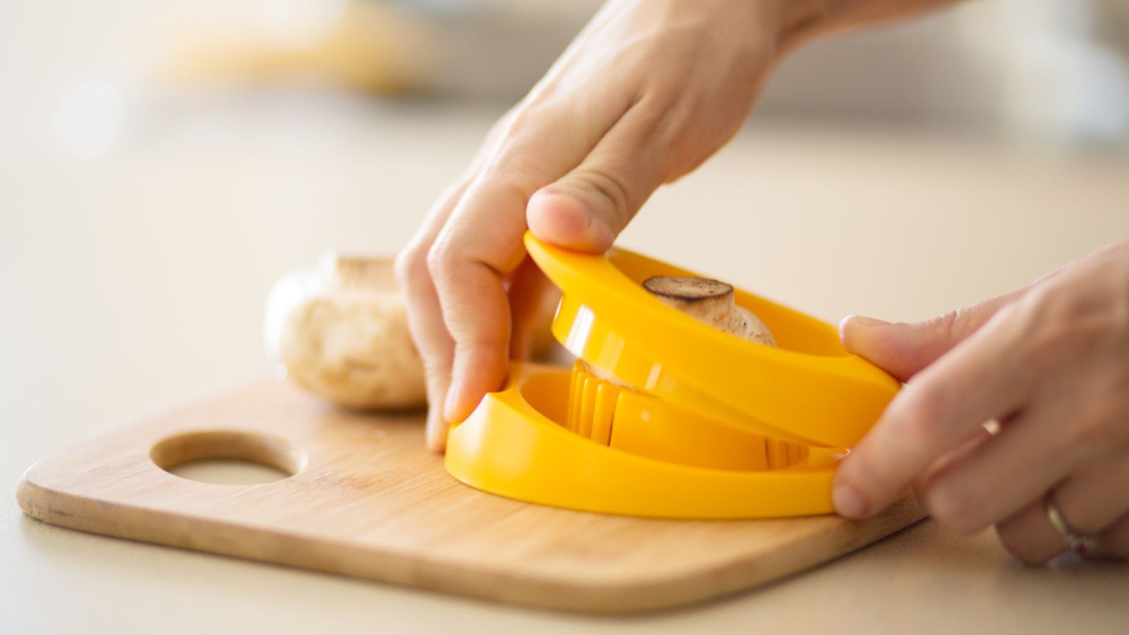 Woman using egg slicer