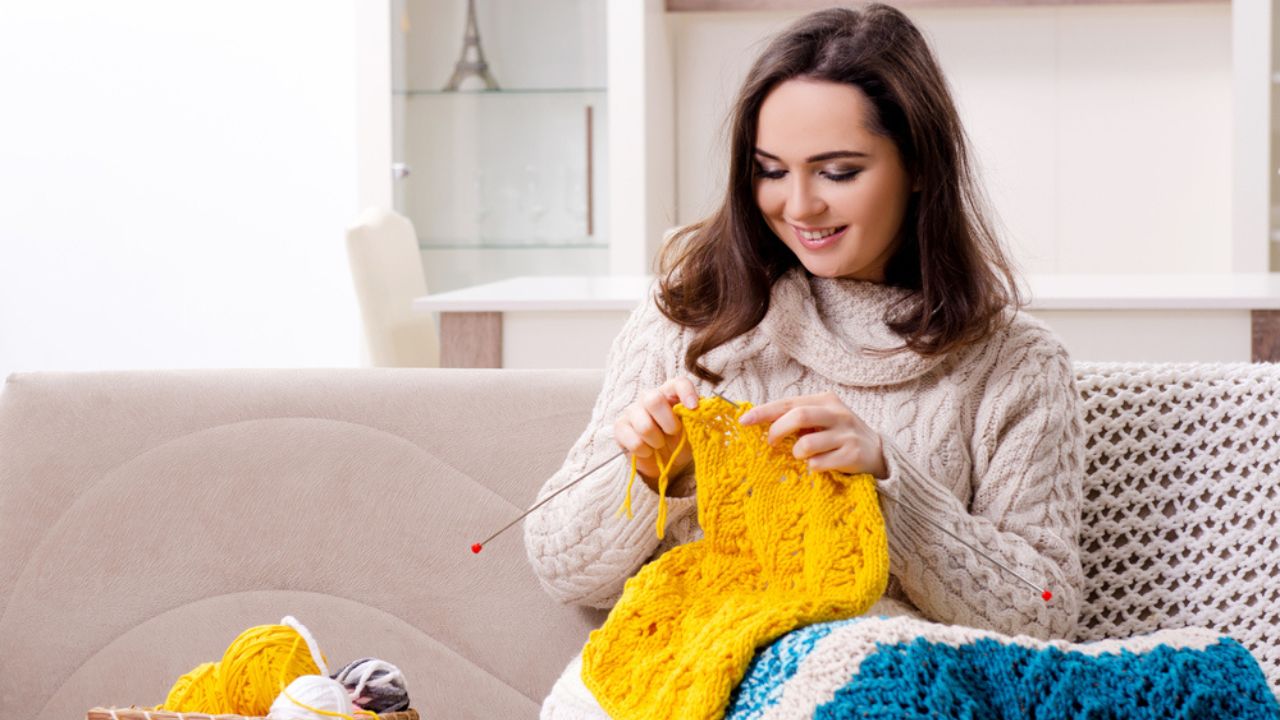 Young Beautiful Woman Knitting at Home
