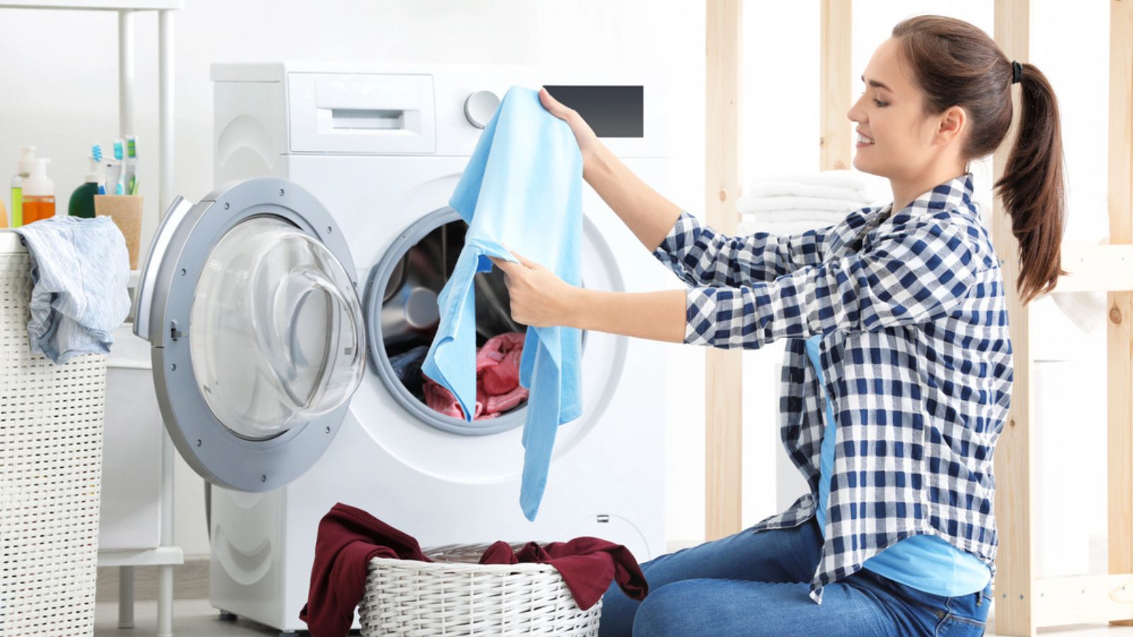 Young woman doing laundry at home