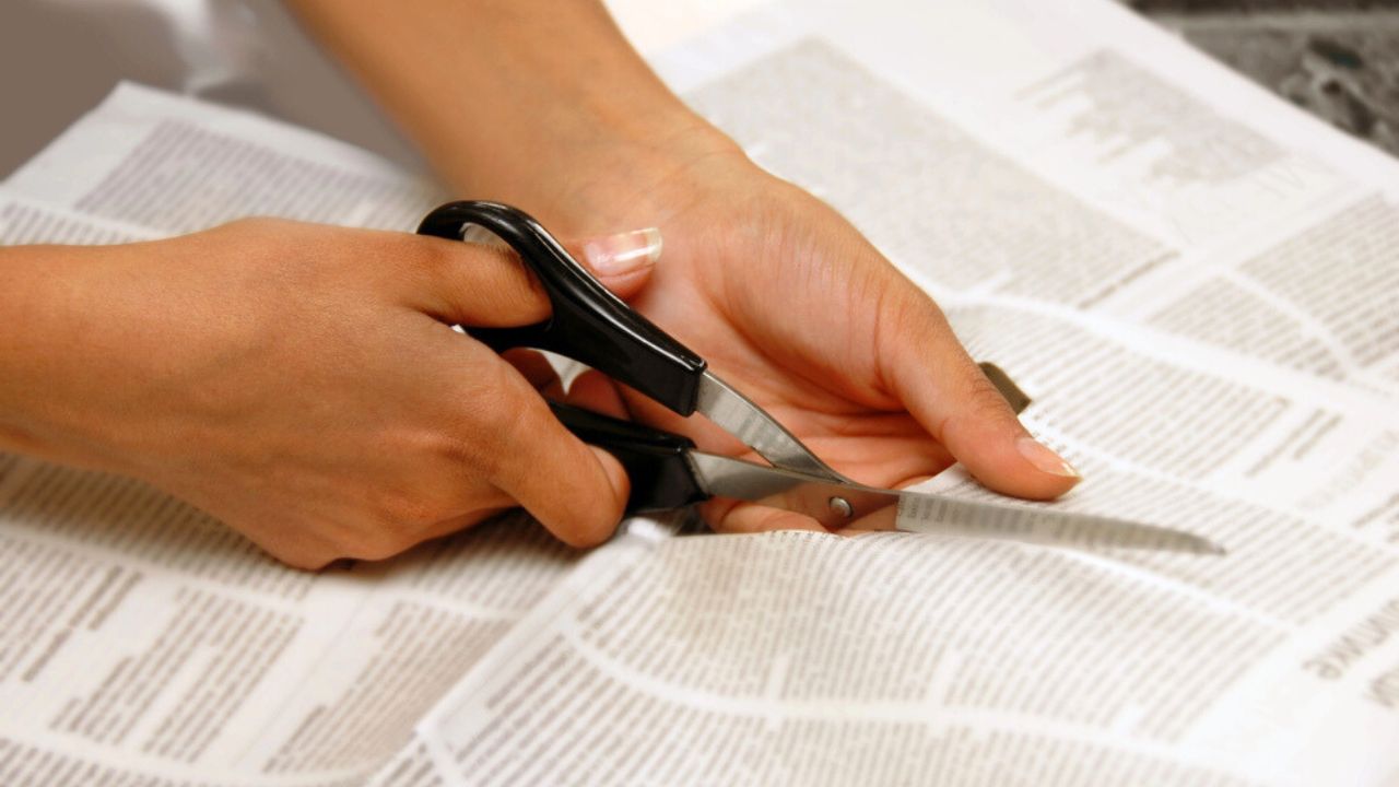 cutting newspaper