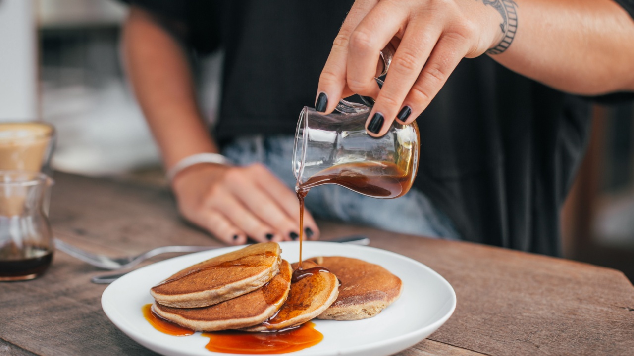 Banana homemade pancakes with maple syrup. Very tasty breakfast