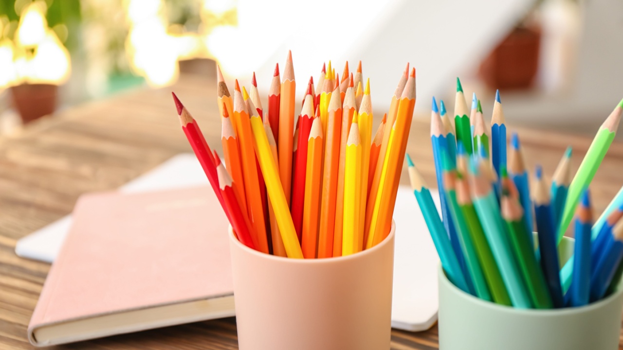 Set of colored pencils in a bucket stand on a desk at school or at home. Background on the theme back to school
