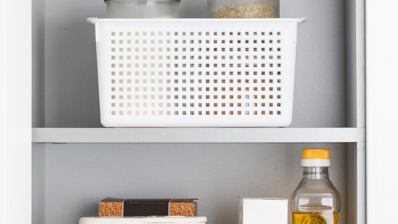 Storage of dry food in plastic containers in the kitchen cabinet. Organization of storage.