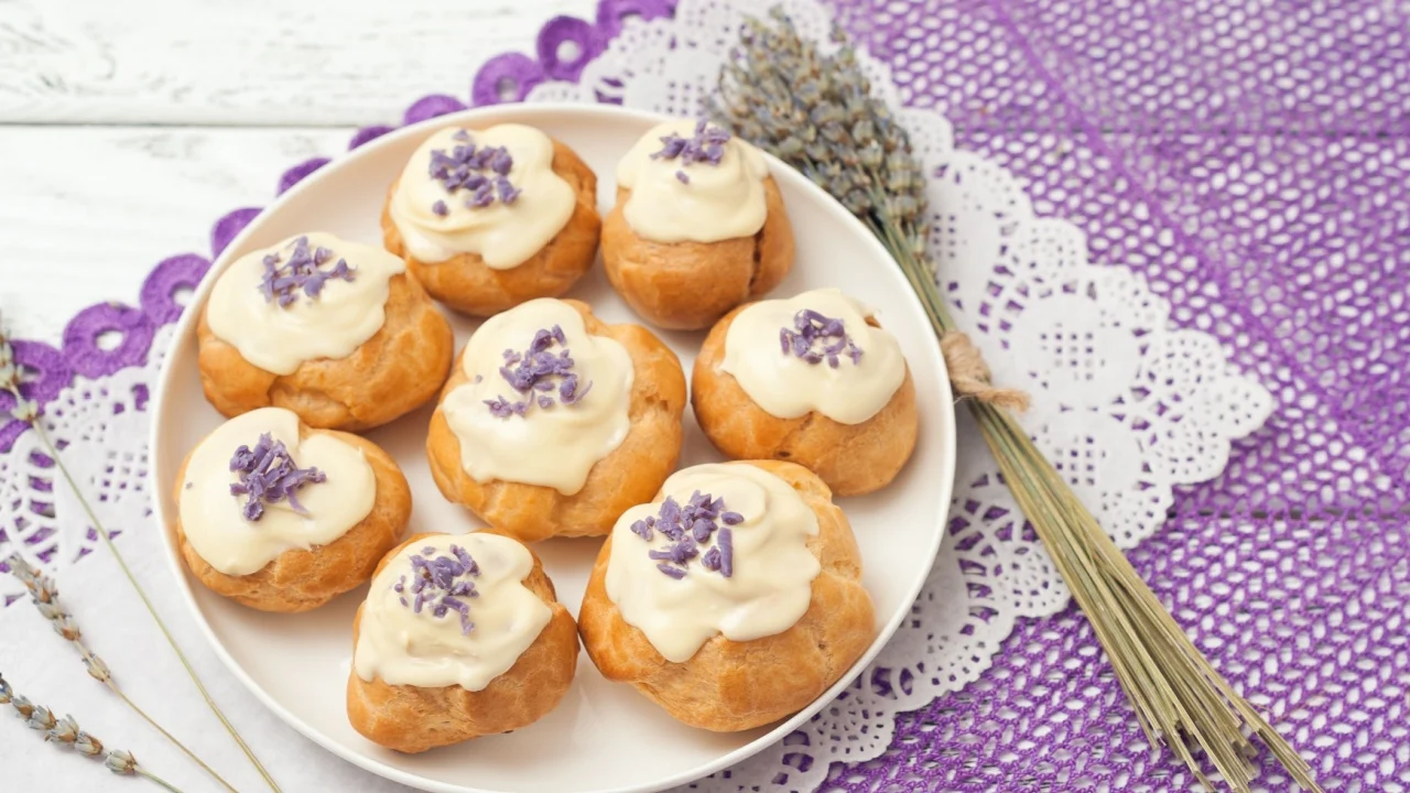 eclairs with lavender custard cream on wooden background