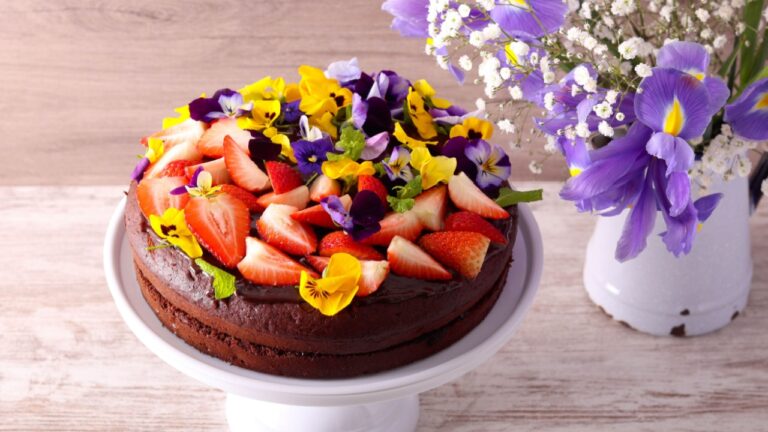 Chocolate sandwich cake with strawberry and edible flowers