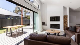 Triple sliding back glass doors from living room to outdoor deck