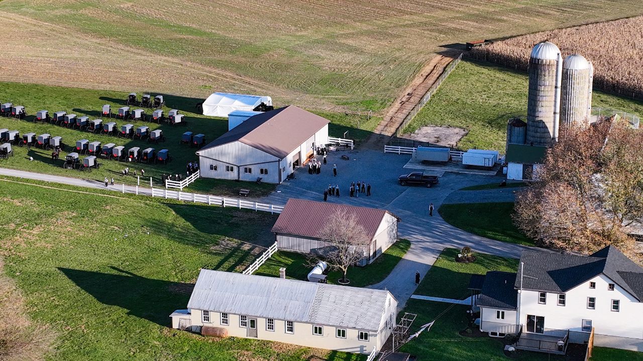 Captured from above, this image showcases an Amish community gathering, with a lineup of traditional horse-drawn buggies. Perfect for pieces on Amish culture
