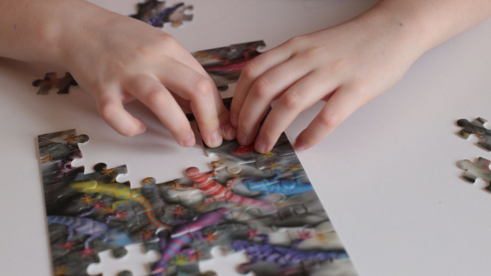 Hands of the child collect puzzles games for the mind and quick wits