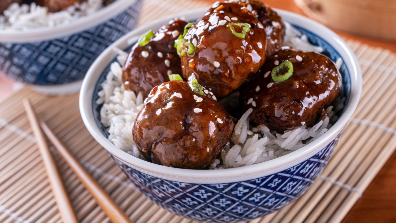 A bowl of delicious honey garlic meatballs with steamed rice.