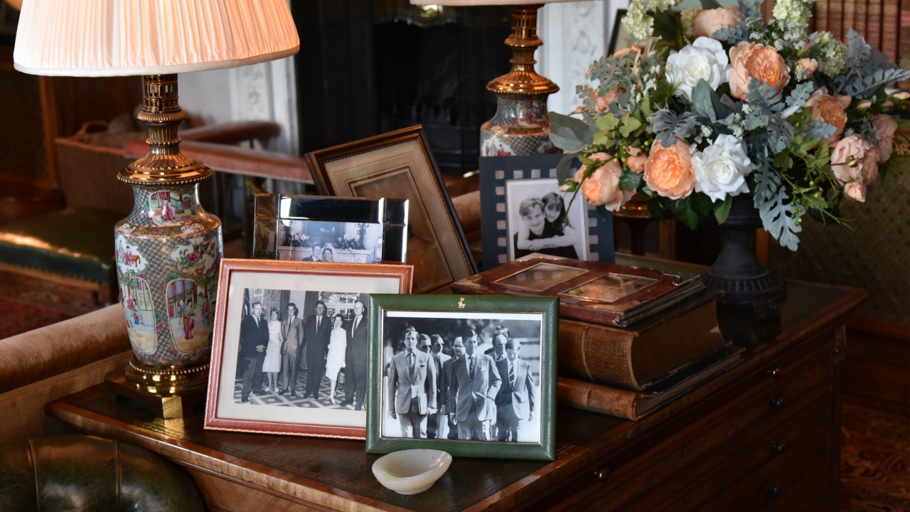 Calne, UK - October 10, 2018: Pictures of Bowood House residents the Petty-Fitzmaurice family, the British royal family with Prince Charles and the Kennedy family are seen on a table in a lounge room.