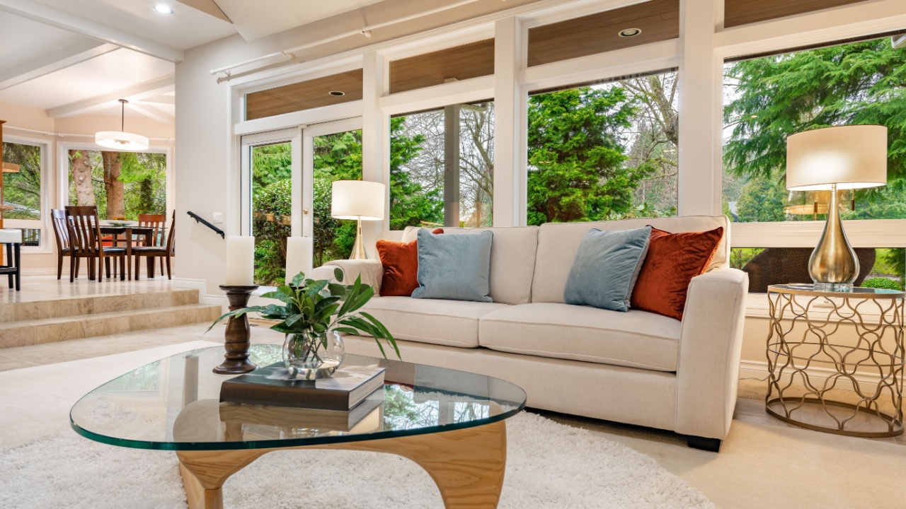 Mid century craftsman house interior living room foyer home office with wood panel walls staircase creative wooden railings stone fireplace in warm white tones and orange accent colors