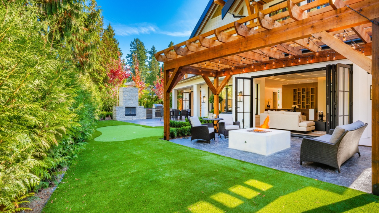 Colorful house with peak roof large windows in autumn fall sunny blue sky and vivid landscaping