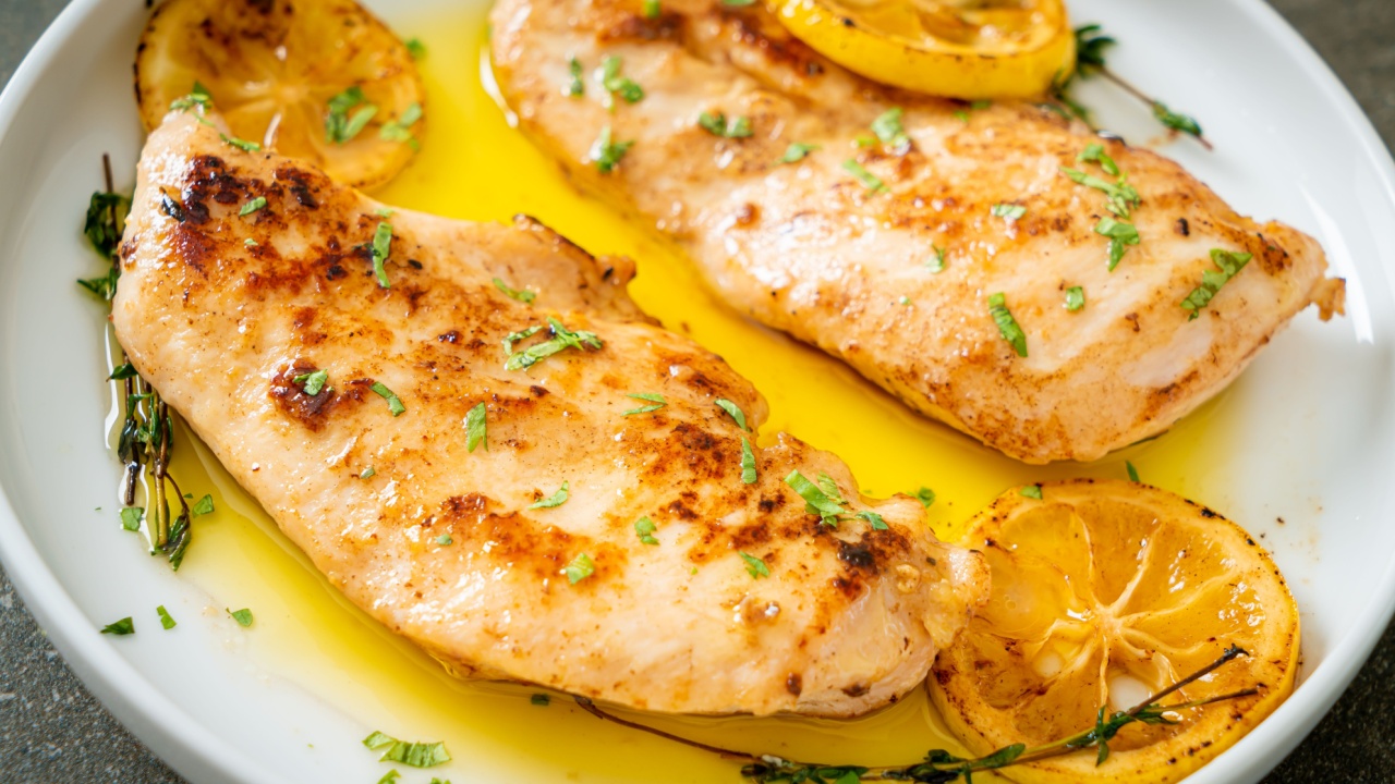 grilled chicken with butter, lemon and garlic on white plate