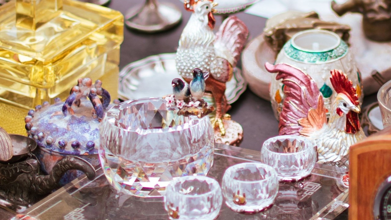 Vintage crystal glassware with mitteleuropea charm and beautiful antique European ornate wooden table clocks in an open-air flea market in Vienna Austria