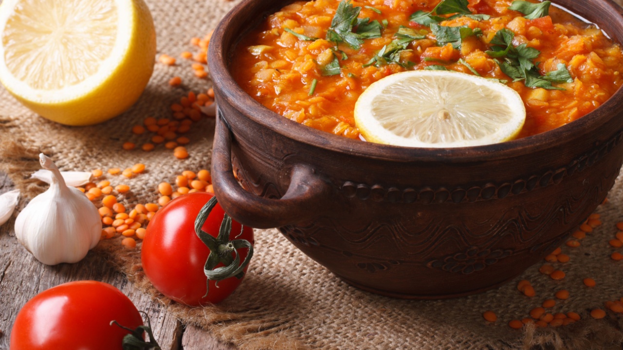 Red lentil soup with vegetables close-up on the table. horizontal, rustic style