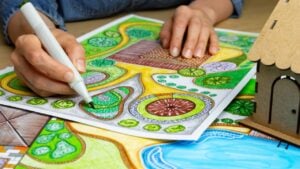 Landscape designer draws a sketch on paper. Layout.