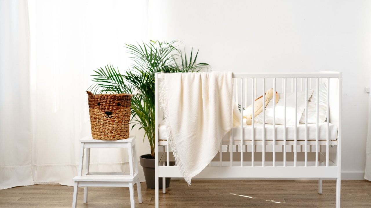 Muslin baby blanket hanging on child's bed in nursing room