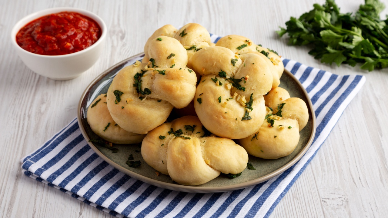Homemade Garlic Knots with Parsley on a Plate, side view.