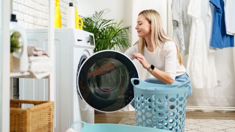 Woman Doing Laundry near a Washing Machine