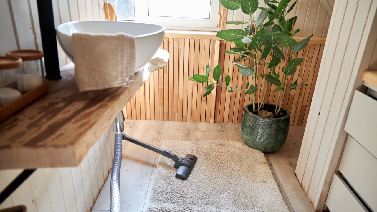 Vacuuming white carpet in the bathroom